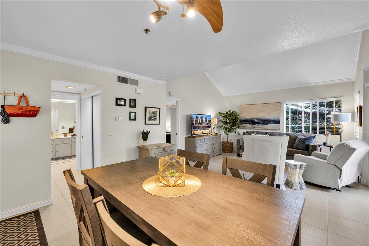 2700 Lawrence Crossley Road, Unit 83 Palm Springs, CA 92264 - Photo 7 of 52 a living room with furniture and a dining table with wooden floor