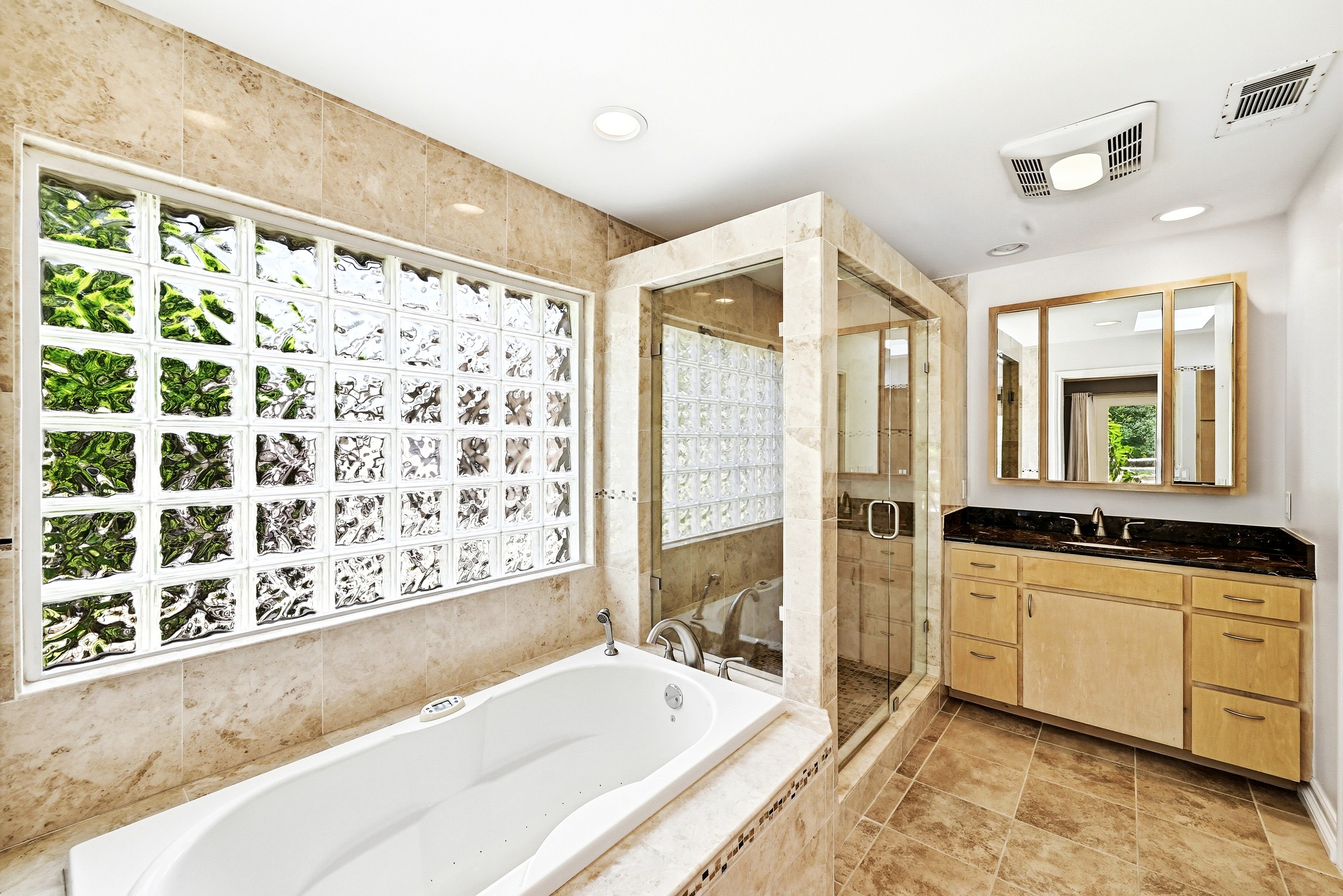 8608 Crest Ridge Circle Austin, TX 78750 - Photo 21 of 38 Indulge in a tranquil bathing experience in this well-appointed bathroom featuring a soaking tub and a spacious glass-enclosed shower.