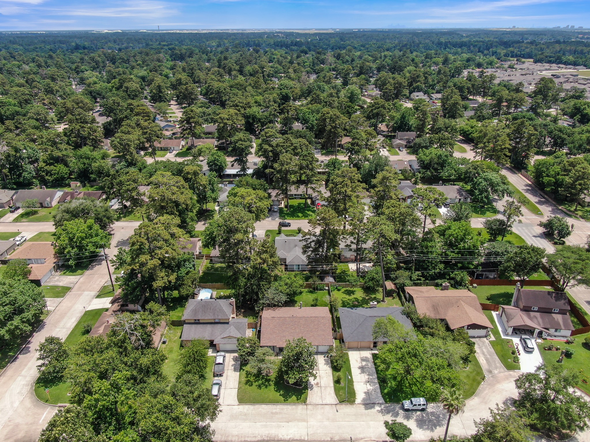 4314 Enchantedgate Drive Spring, TX 77373 - Photo 46 of 47 Aerial photo showcases a serene suburban neighborhood with tree-lined streets and well-spaced houses. The area is lush with greenery, providing a tranquil and inviting environment.