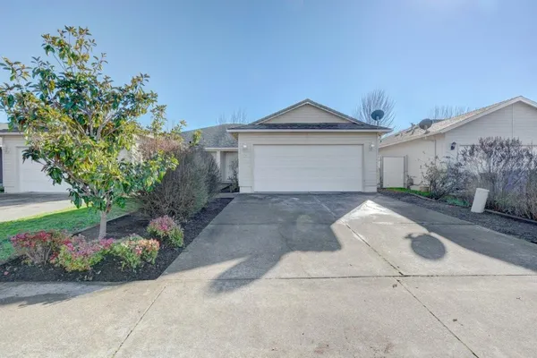a front view of a house with a yard and a garage