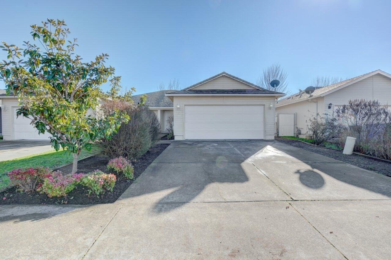417 Crystal Drive Eagle Point, OR 97524 - Photo 1 of 35 a front view of a house with a yard and a garage