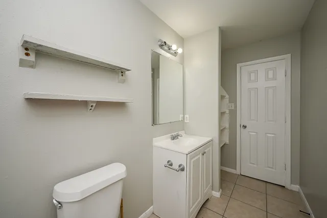 a bathroom with a toilet sink and mirror