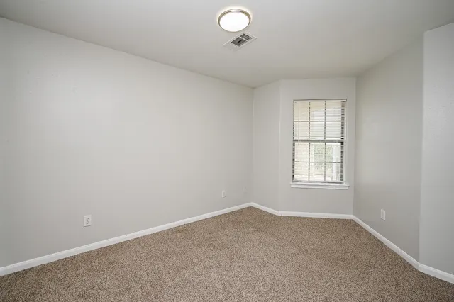 an empty room with a empty space and windows