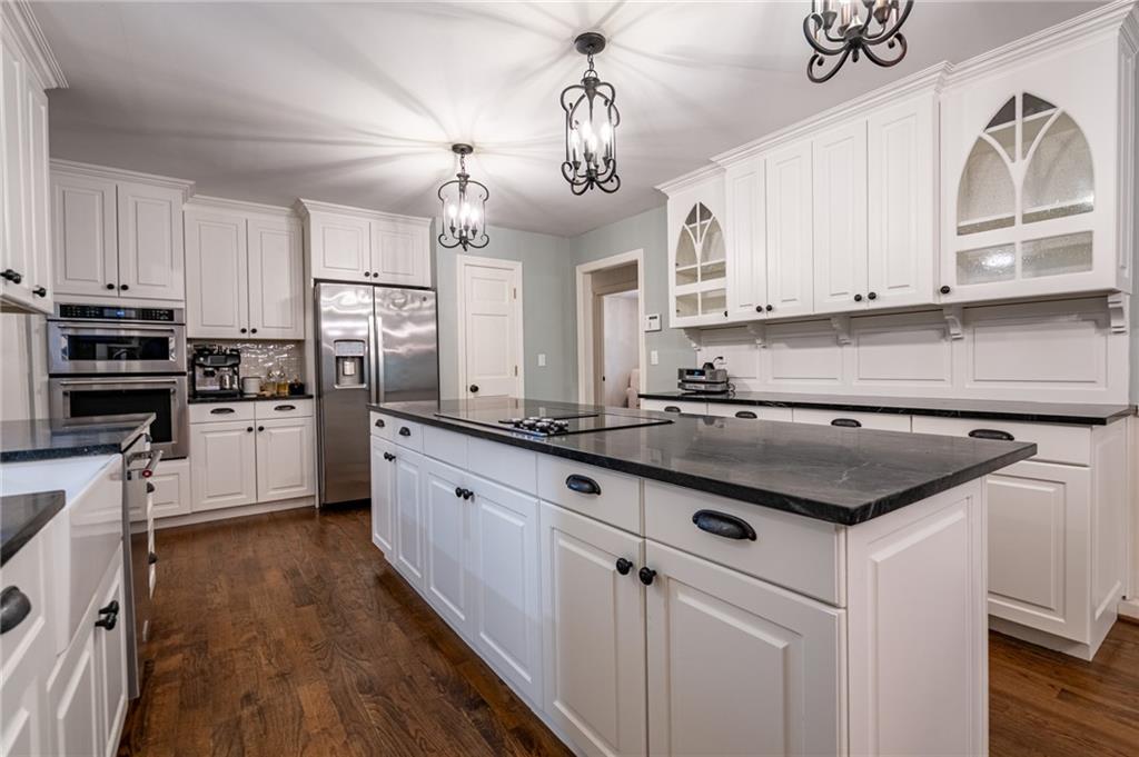 4067 Mason Creek Road Winston, GA 30187 - Photo 17 of 48 a kitchen with kitchen island granite countertop a sink cabinets and stainless steel appliances