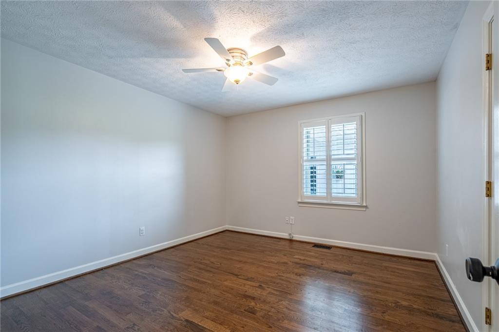 4067 Mason Creek Road Winston, GA 30187 - Photo 26 of 48 an empty room with wooden floor and windows