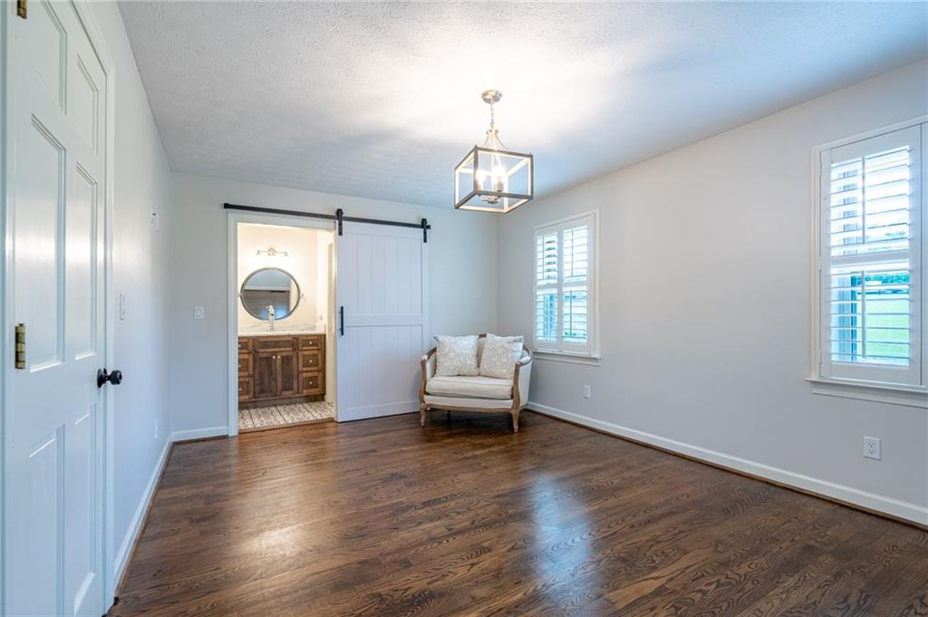 4067 Mason Creek Road Winston, GA 30187 - Photo 27 of 48 a living room with furniture and a chandelier