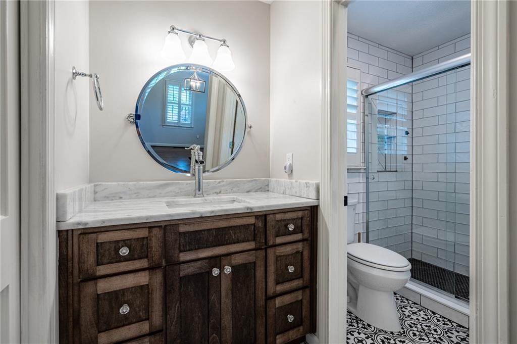 4067 Mason Creek Road Winston, GA 30187 - Photo 28 of 48 a bathroom with a toilet a sink and mirror