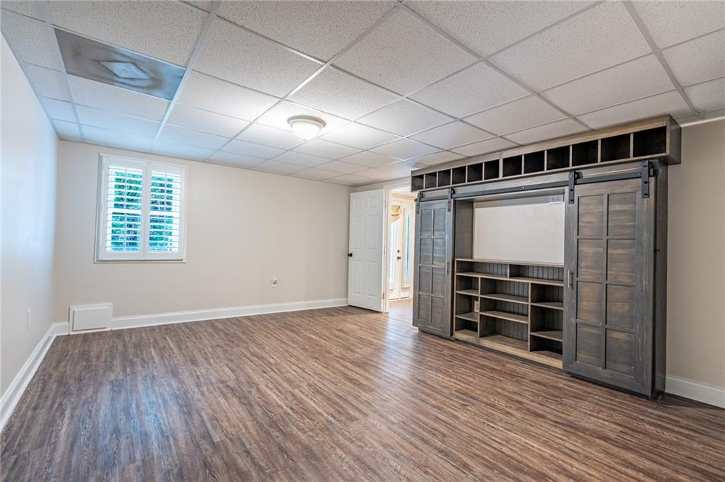 4067 Mason Creek Road Winston, GA 30187 - Photo 37 of 48 a view of empty room with wooden floor and windows