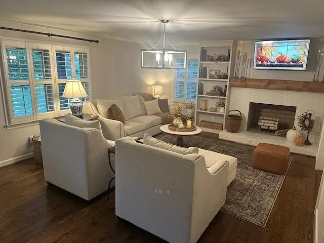a living room with furniture a fireplace and a flat screen tv