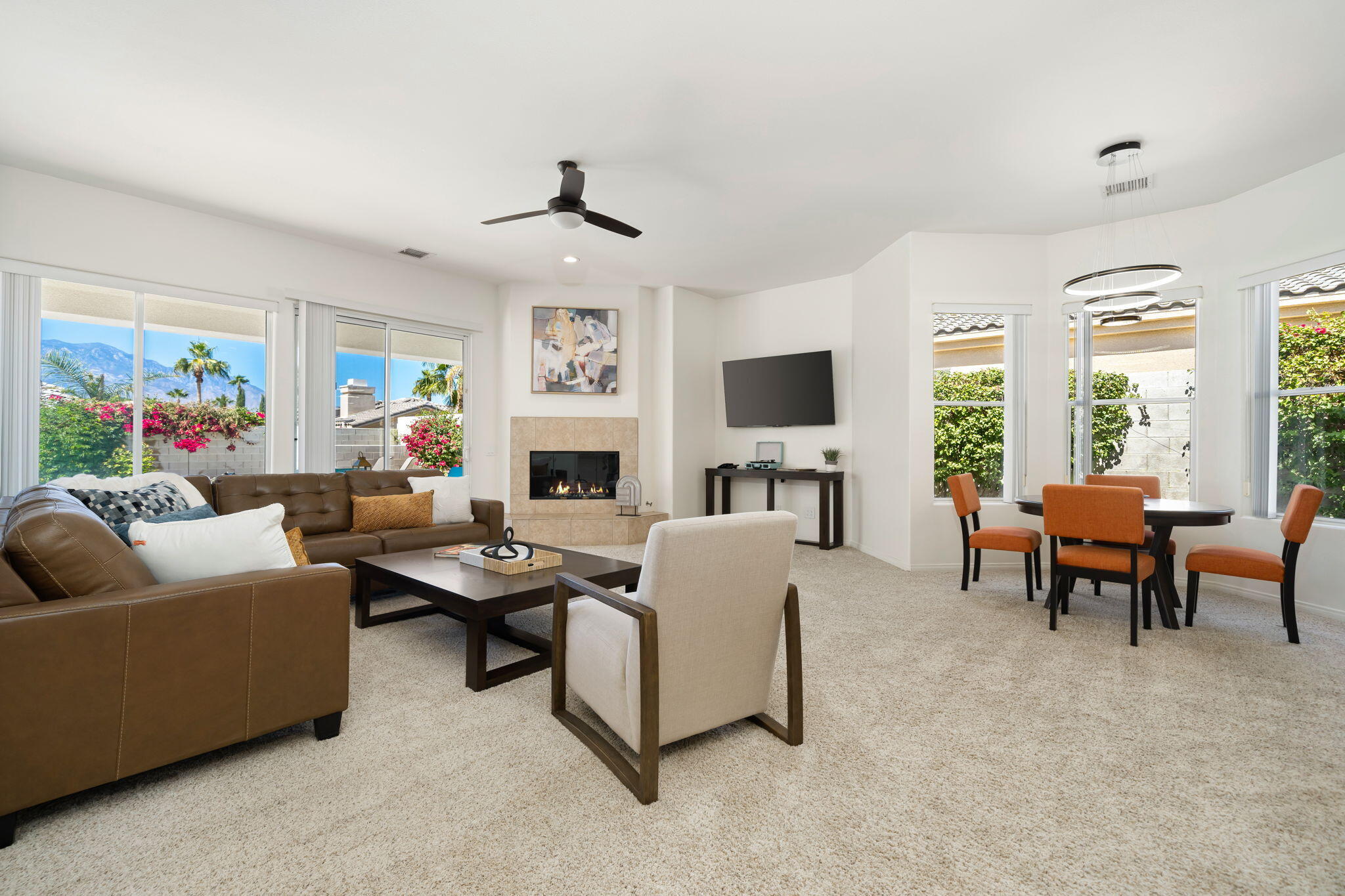 1 Waterloo Court Rancho Mirage, CA 92270 - Photo 20 of 54 a living room with furniture flat screen tv and a fireplace