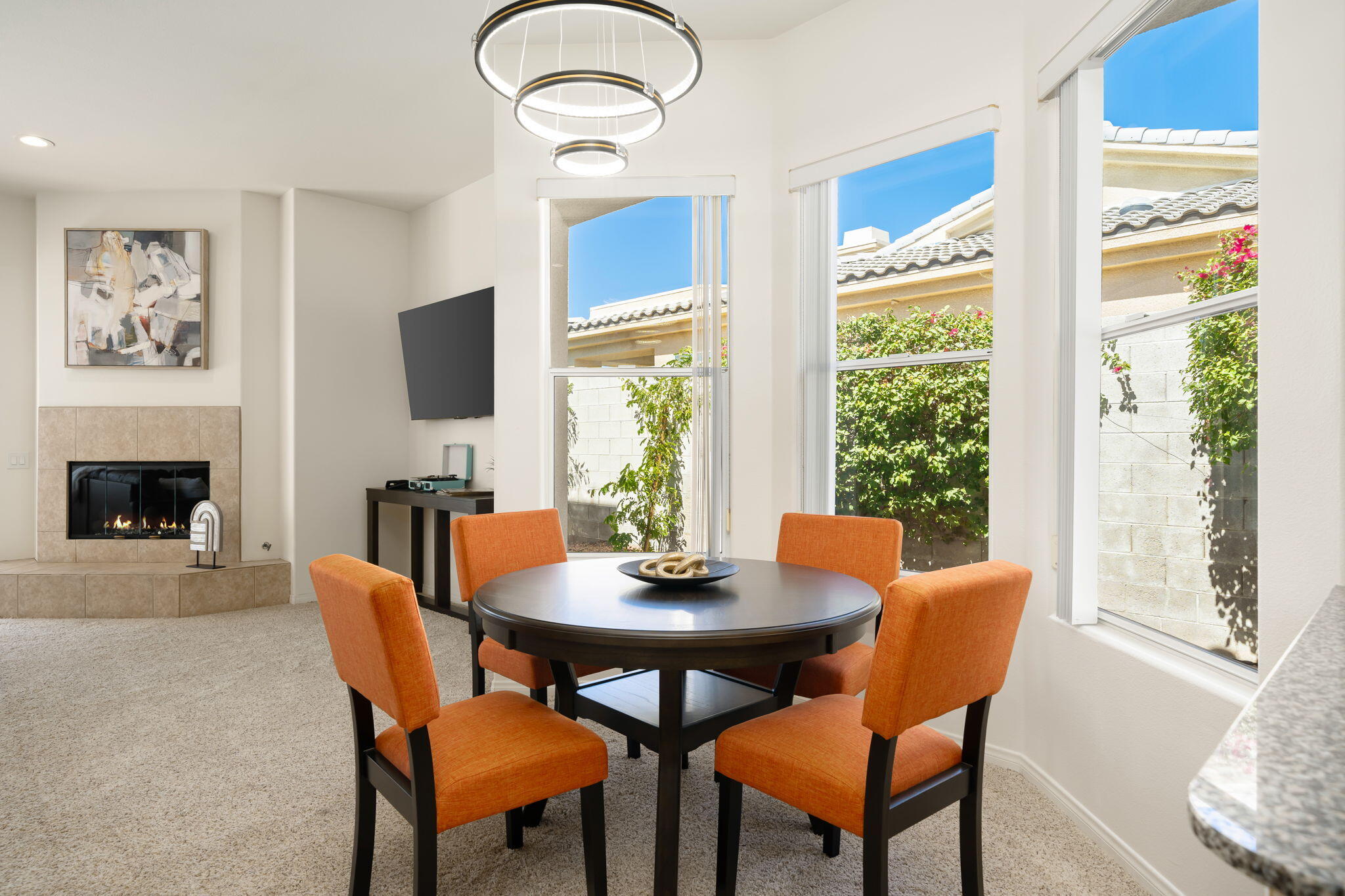 1 Waterloo Court Rancho Mirage, CA 92270 - Photo 26 of 54 a dining room with furniture a window and a fireplace