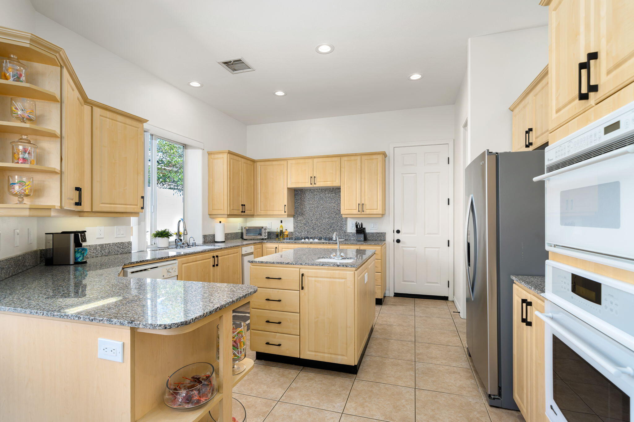 1 Waterloo Court Rancho Mirage, CA 92270 - Photo 27 of 54 a kitchen with stainless steel appliances granite countertop a sink stove and refrigerator