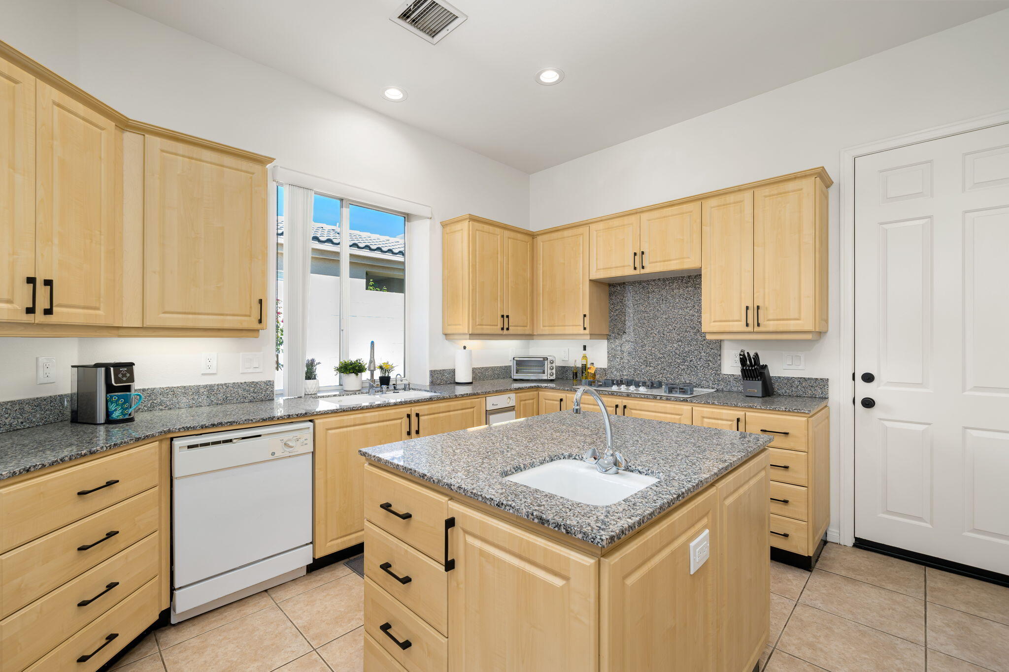 1 Waterloo Court Rancho Mirage, CA 92270 - Photo 29 of 54 a kitchen with granite countertop cabinets stainless steel appliances a sink and a window