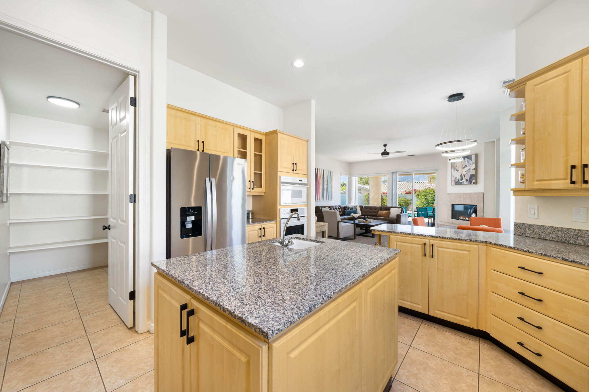 1 Waterloo Court Rancho Mirage, CA 92270 - Photo 30 of 54 a kitchen with granite countertop a sink stove and refrigerator