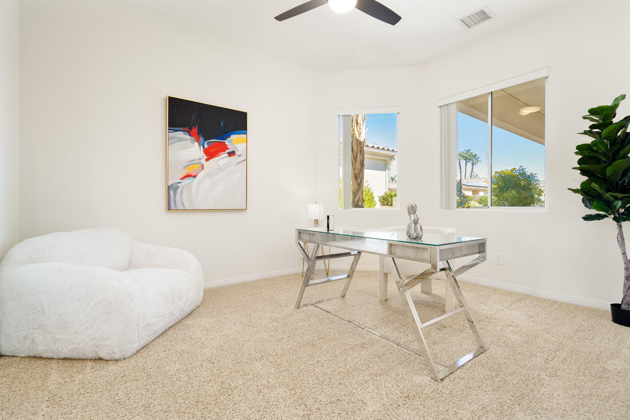 1 Waterloo Court Rancho Mirage, CA 92270 - Photo 40 of 54 a living room with furniture and a painting on the wall