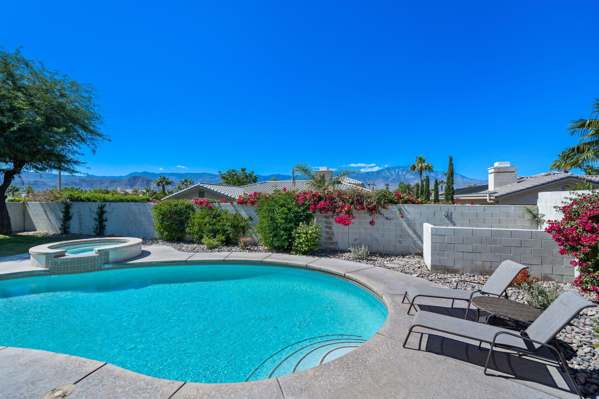 1 Waterloo Court Rancho Mirage, CA 92270 - Photo 48 of 54 a view of a chairs and table in the backyard