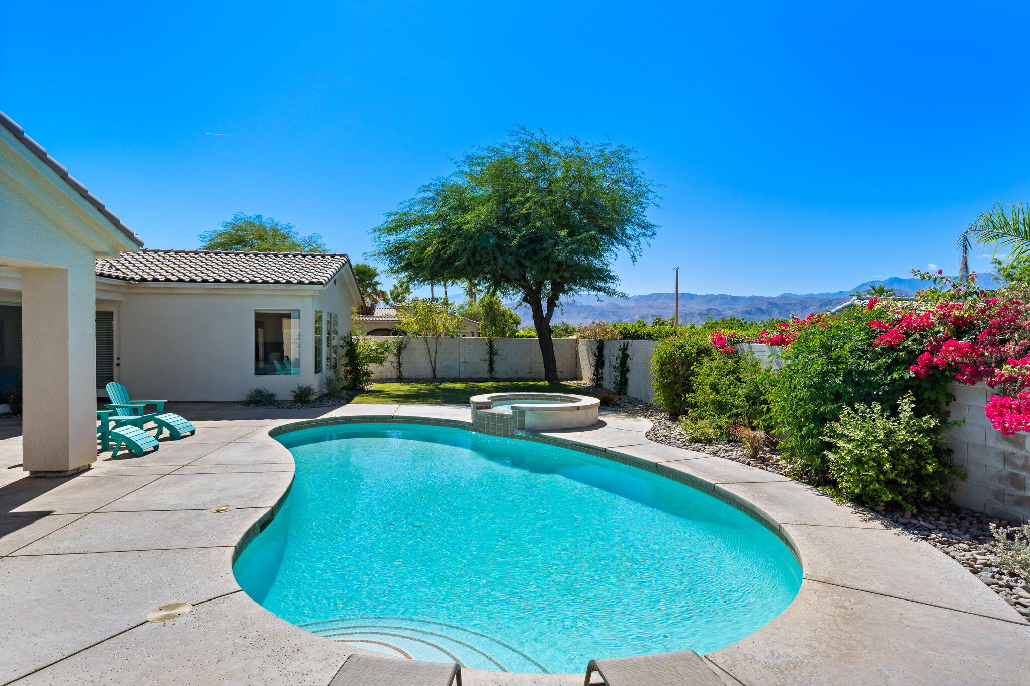 1 Waterloo Court Rancho Mirage, CA 92270 - Photo 49 of 54 a view of a swimming pool with a lounge chairs