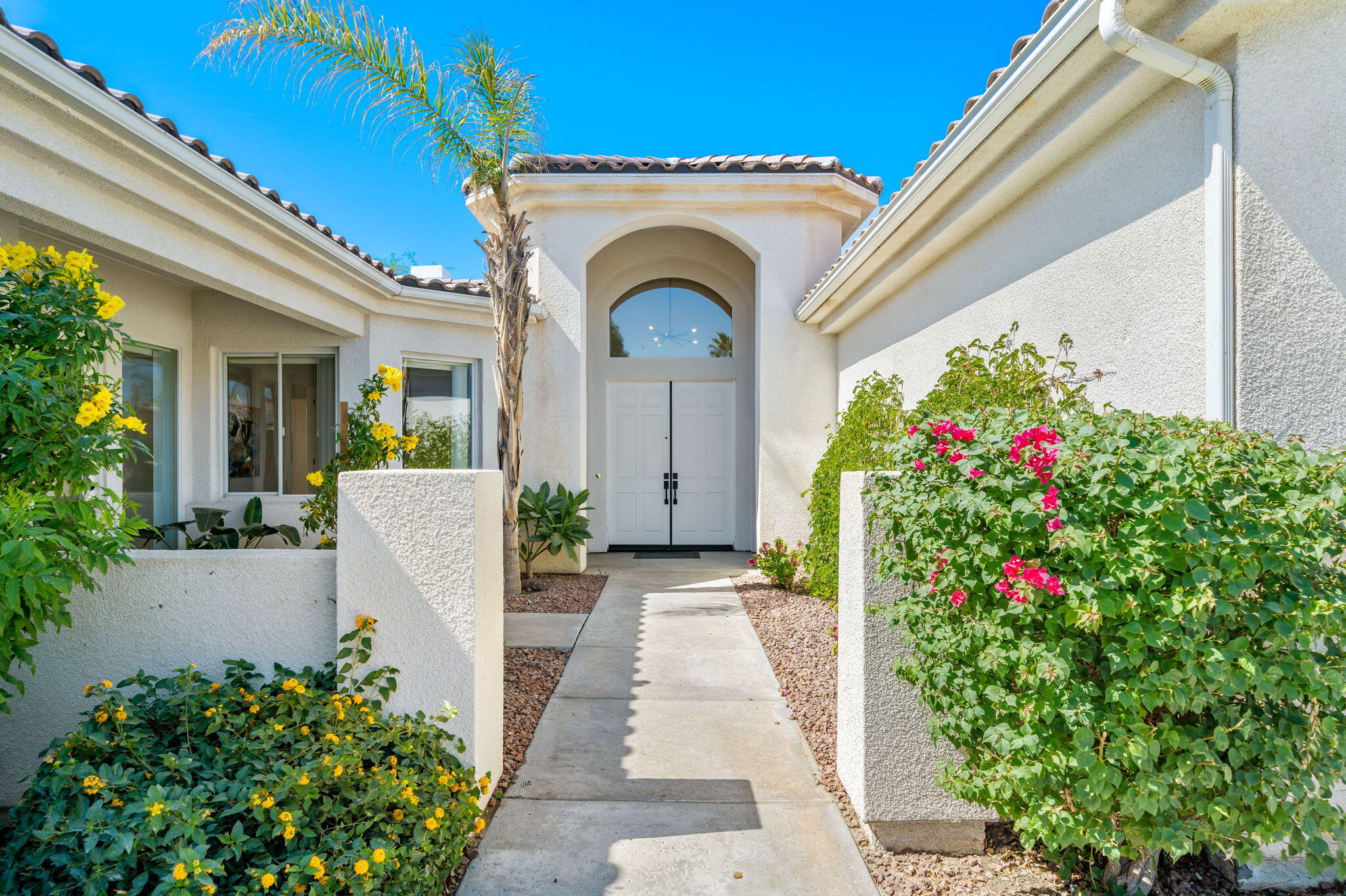 1 Waterloo Court Rancho Mirage, CA 92270 - Photo 8 of 54 a view of a house with a flower garden