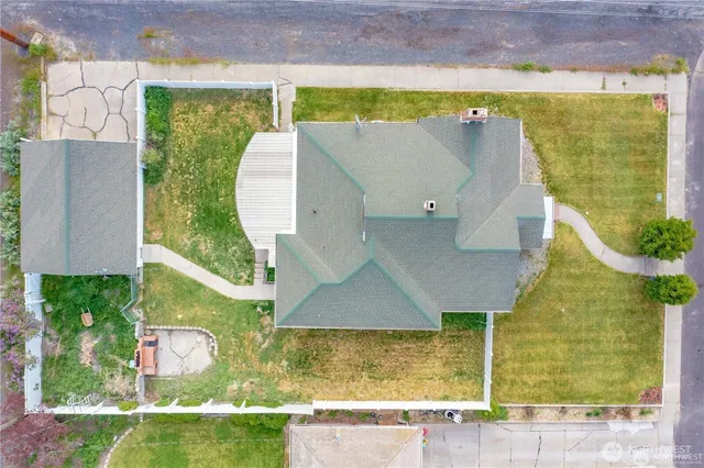 an aerial view of residential house with pool and yard