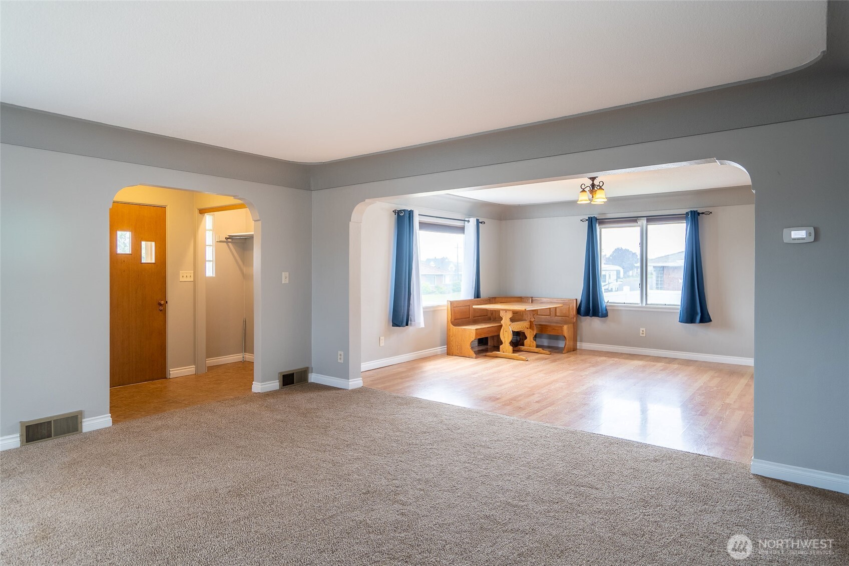 113 East 6th Street Lind, WA 99341 - Photo 9 of 38 an empty room with windows and chandelier