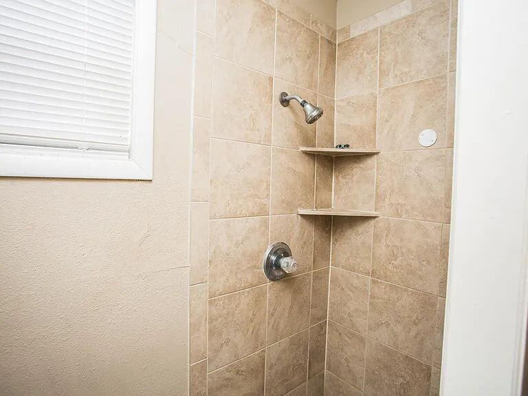 4309 42nd Street Lubbock, TX 79413 - Photo 12 of 21 a bathroom with a shower