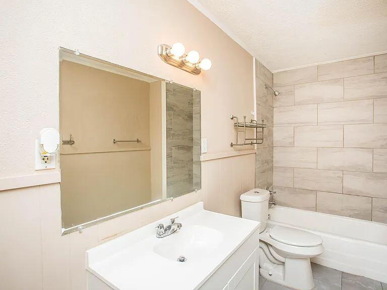 4309 42nd Street Lubbock, TX 79413 - Photo 15 of 21 a bathroom with a sink a toilet and shower