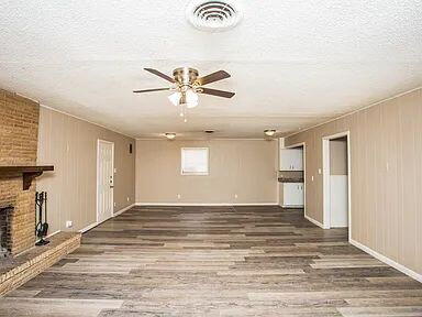 4309 42nd Street Lubbock, TX 79413 - Photo 2 of 21 a view of an empty room with window and wooden floor