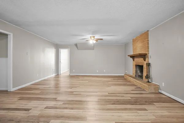 a living room with a fireplace and a wooden floor