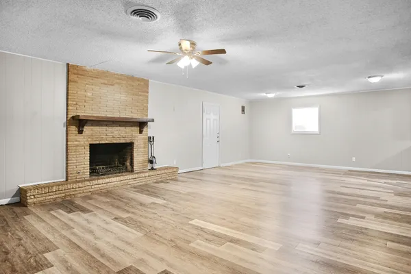 a kitchen with a sink a refrigerator and white cabinets