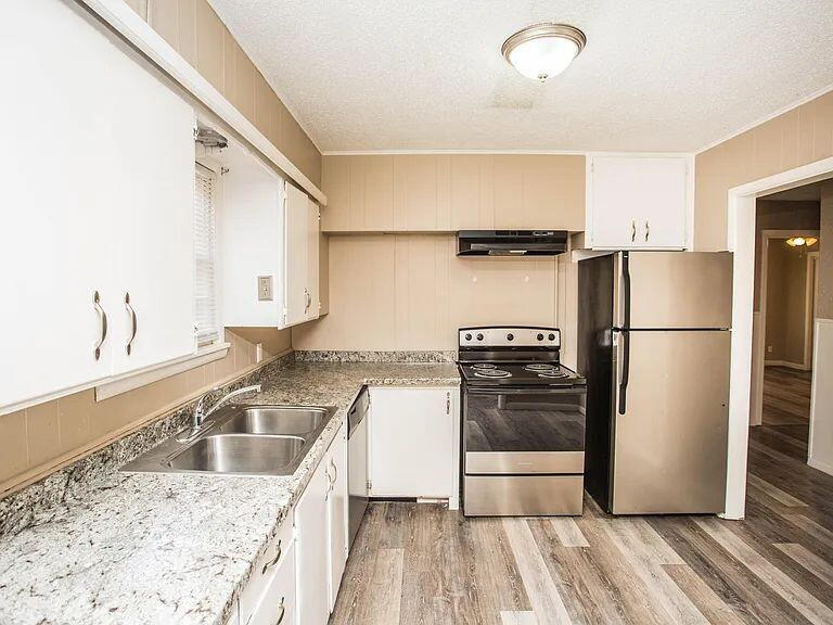 4309 42nd Street Lubbock, TX 79413 - Photo 6 of 21 a kitchen with a refrigerator sink and stove