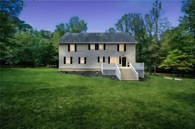 a front view of a house with a yard table and chairs