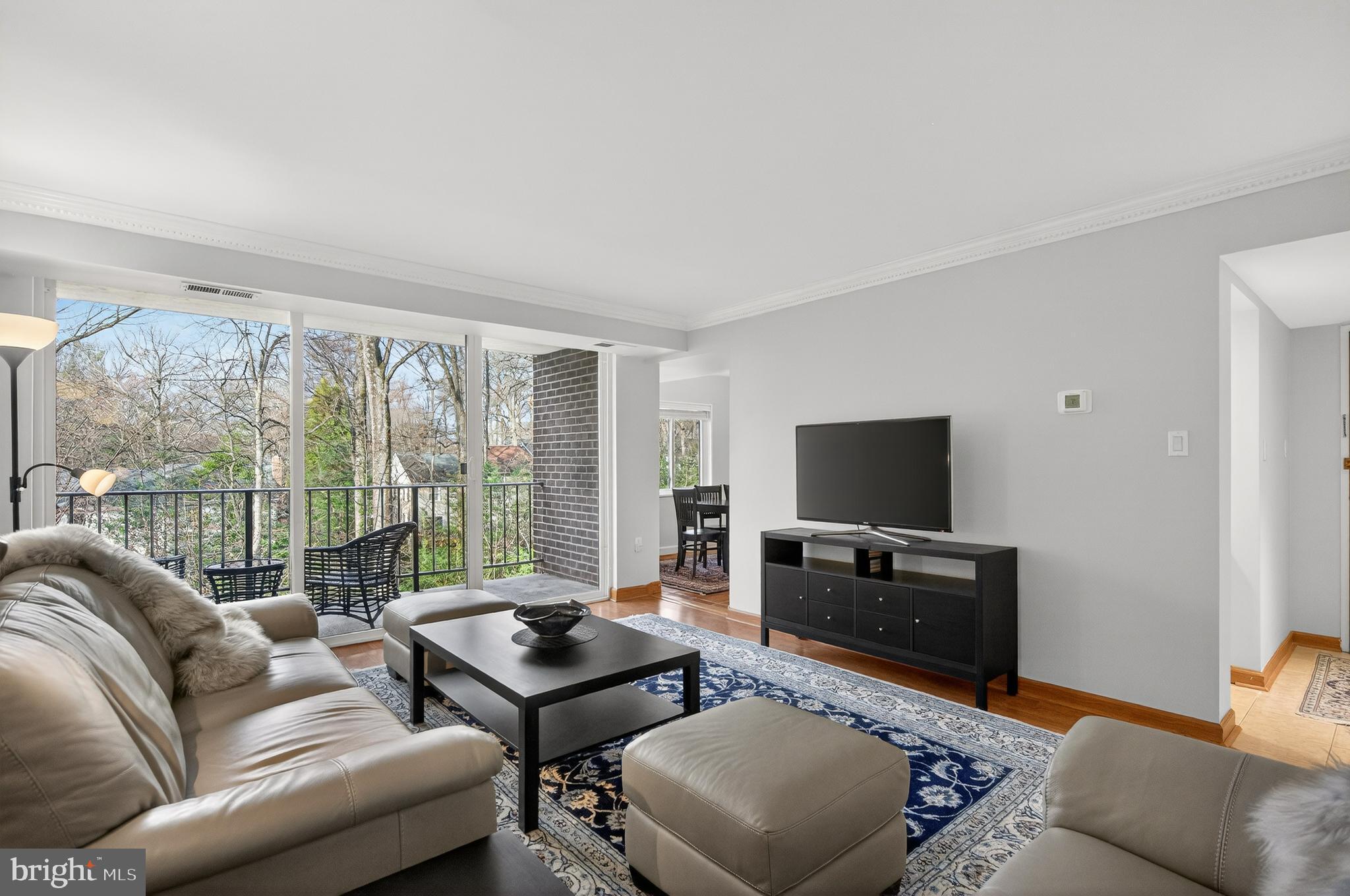 1536 Northgate Square, Unit 21 Reston, VA 20190 - Photo 12 of 50 a living room with furniture a flat screen tv and a large window