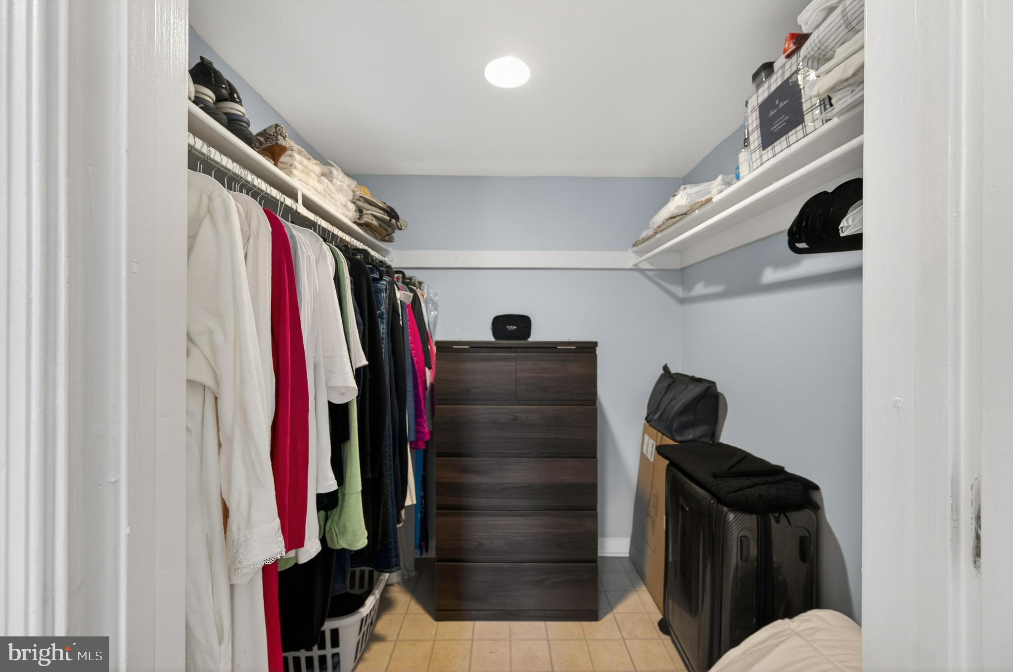 1536 Northgate Square, Unit 21 Reston, VA 20190 - Photo 20 of 50 a view of walk in closet with clothes and shoes