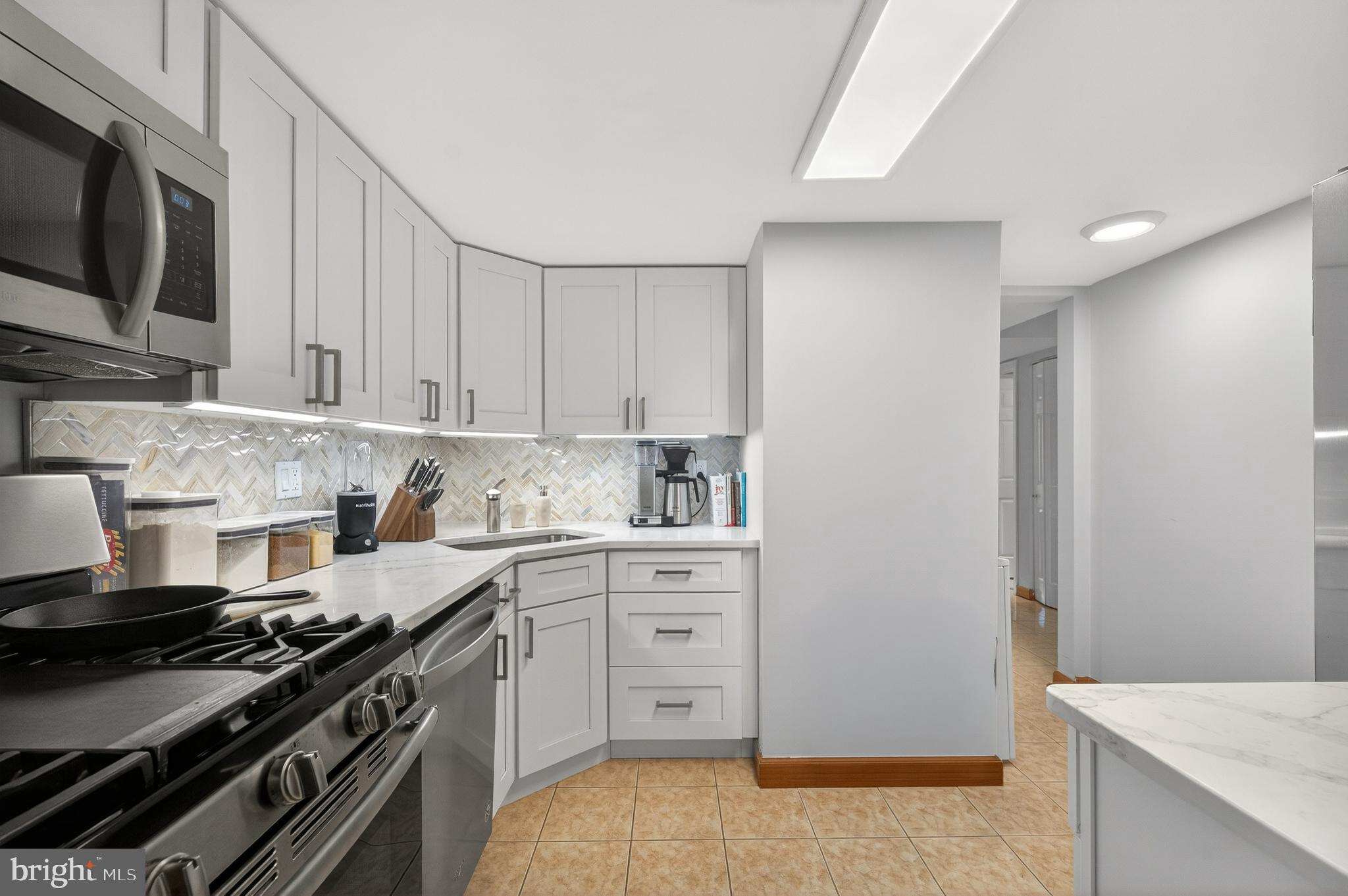 1536 Northgate Square, Unit 21 Reston, VA 20190 - Photo 2 of 50 a kitchen with stainless steel appliances a stove a sink and white cabinets