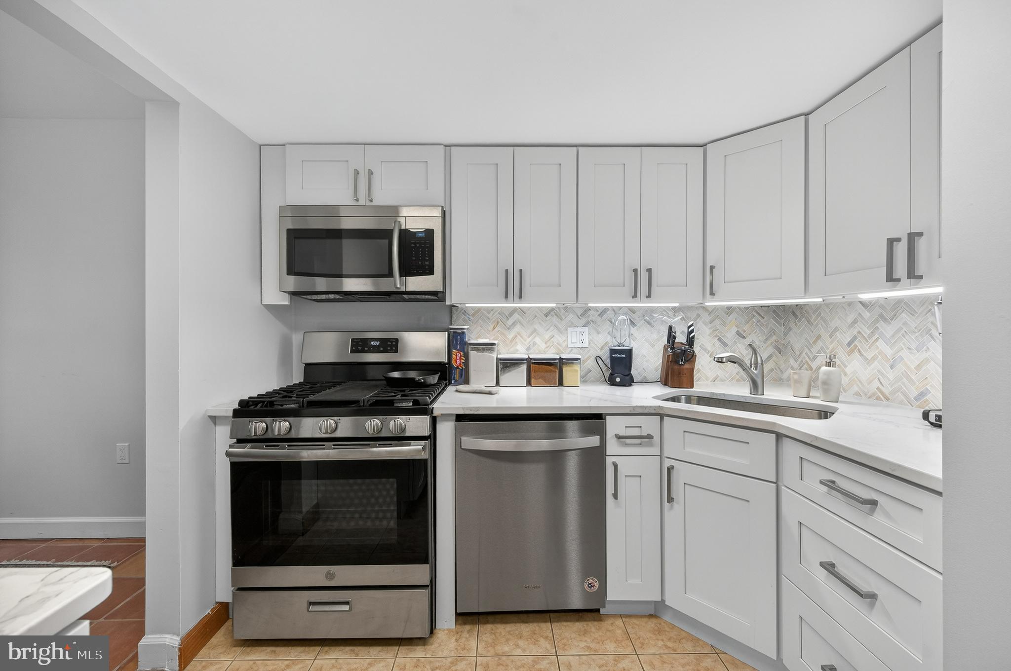 1536 Northgate Square, Unit 21 Reston, VA 20190 - Photo 8 of 50 a kitchen with cabinets stainless steel appliances and a sink
