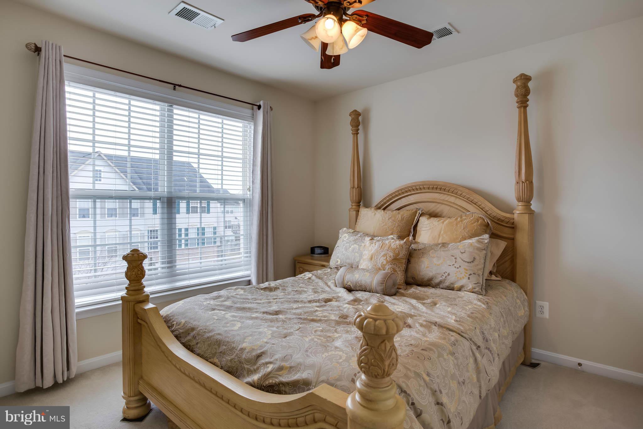 2242 Henry Watts Loop Woodbridge, VA 22191 - Photo 20 of 30 a bedroom with a bed and window