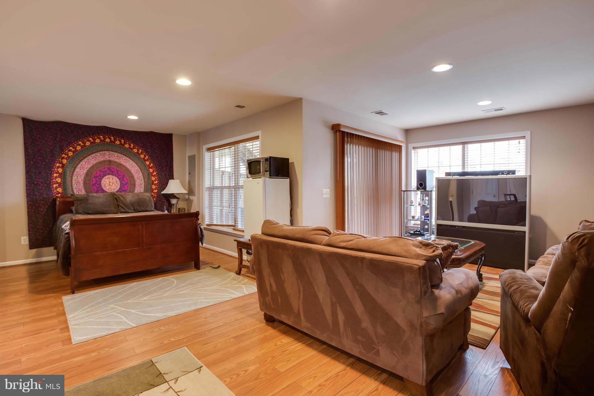 2242 Henry Watts Loop Woodbridge, VA 22191 - Photo 22 of 30 a living room with furniture and a flat screen tv