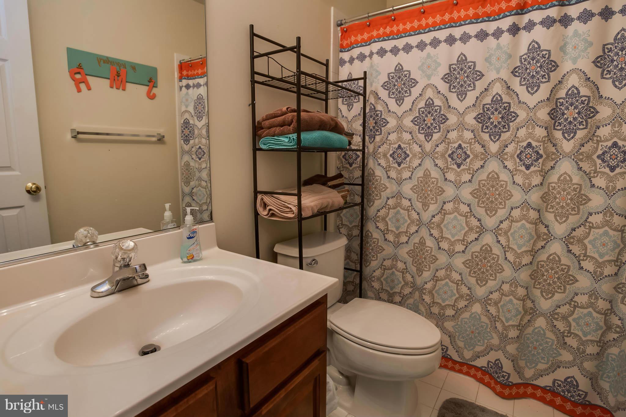 2242 Henry Watts Loop Woodbridge, VA 22191 - Photo 23 of 30 a bathroom with a sink toilet and shower