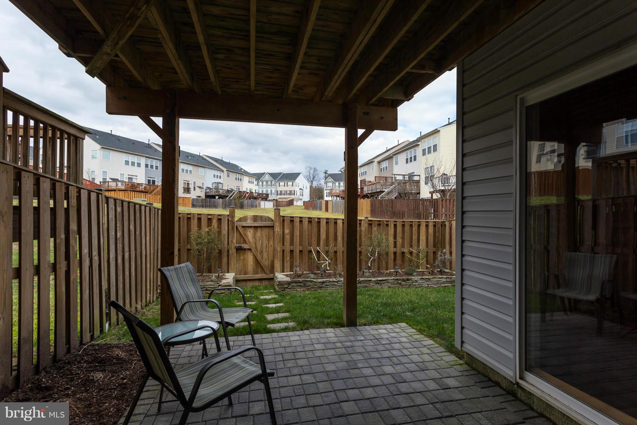 2242 Henry Watts Loop Woodbridge, VA 22191 - Photo 27 of 30 a patio with table and chairs