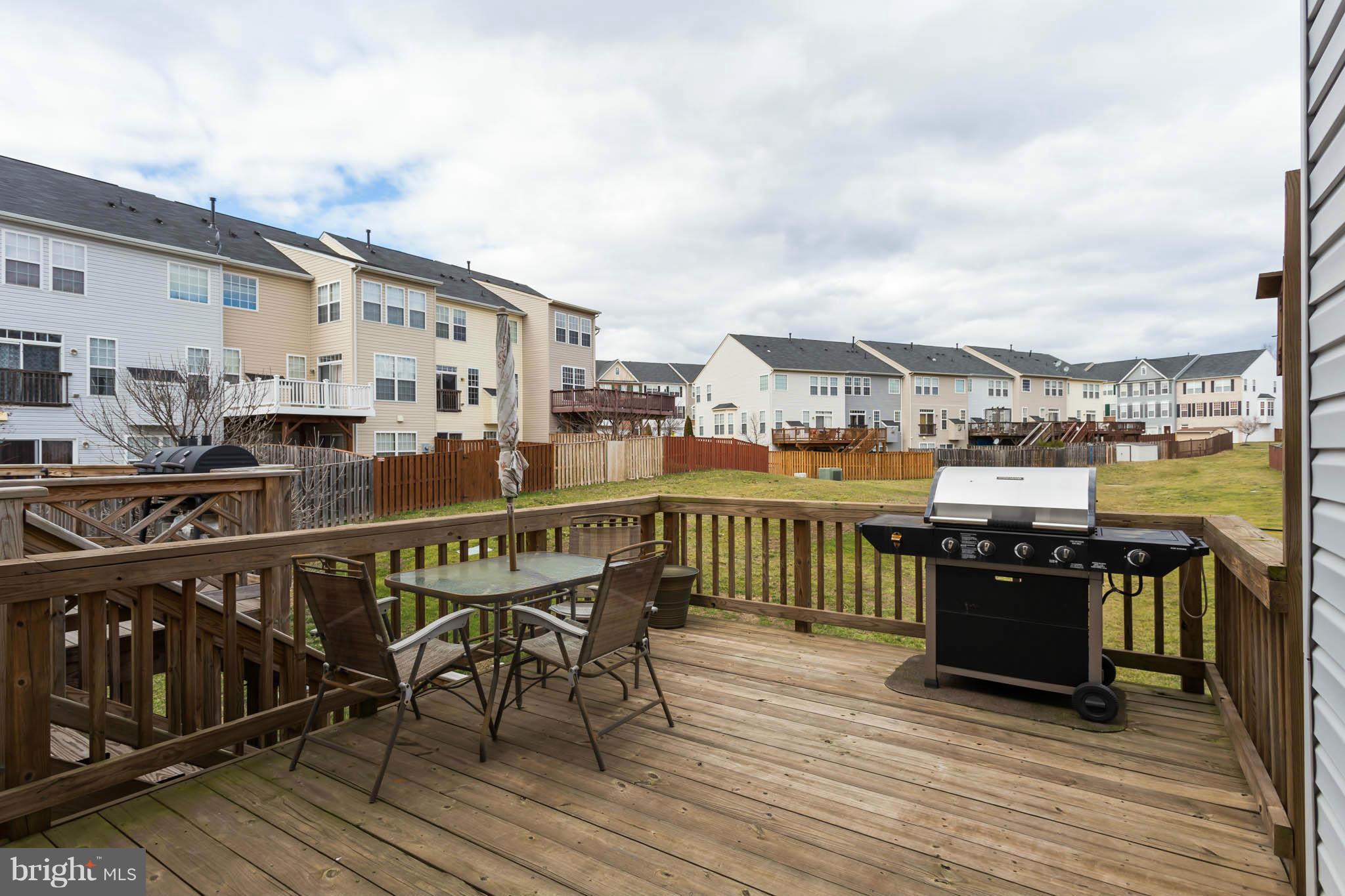 2242 Henry Watts Loop Woodbridge, VA 22191 - Photo 28 of 30 a roof deck with a barbeque and wooden floor
