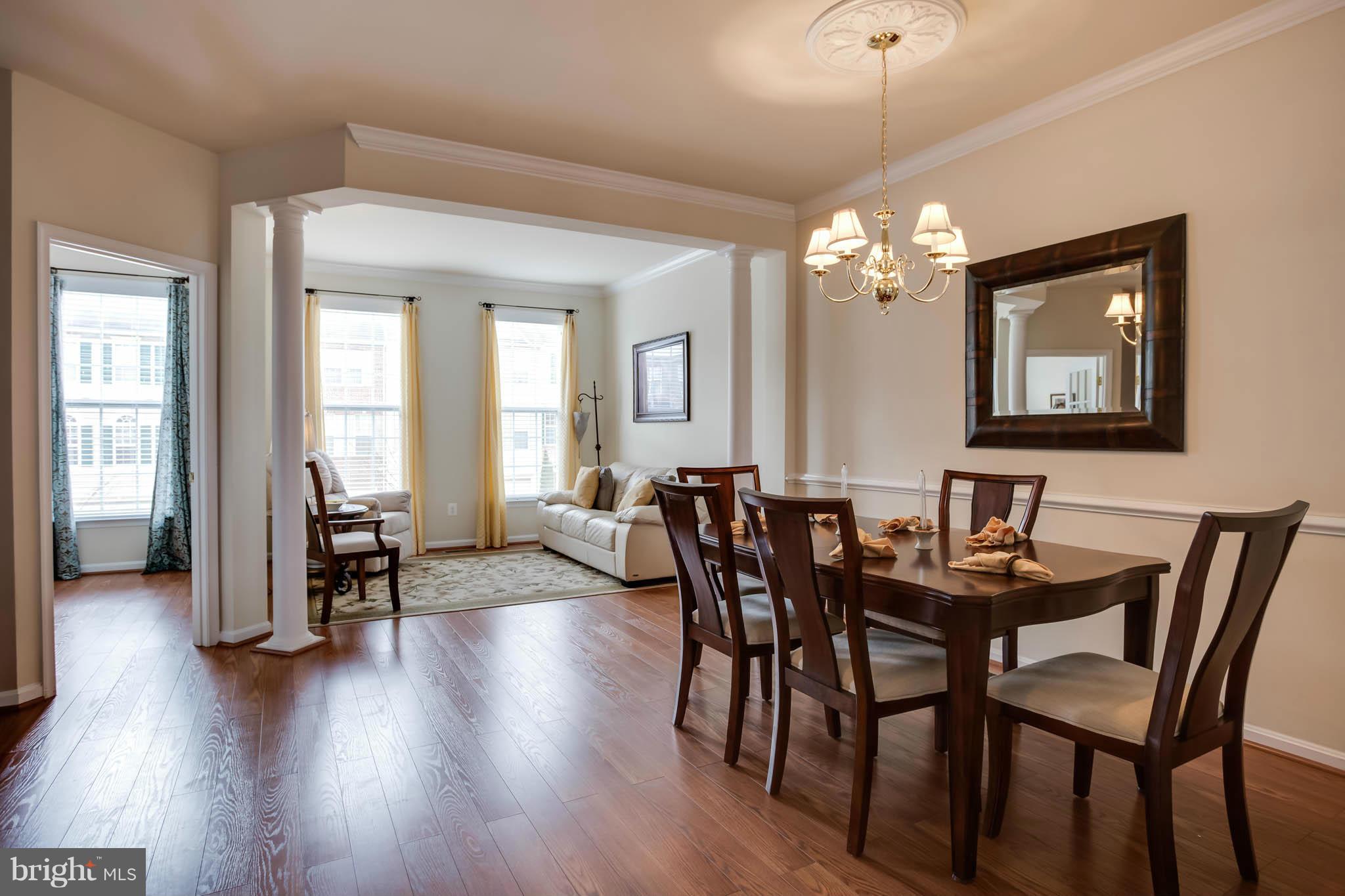 2242 Henry Watts Loop Woodbridge, VA 22191 - Photo 6 of 30 a view of a a dining room with furniture window and wooden floor