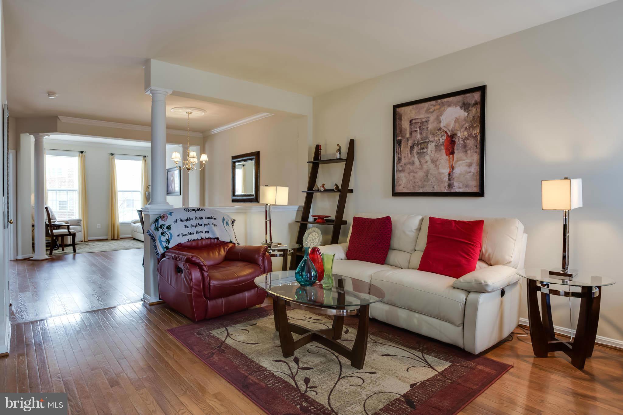 2242 Henry Watts Loop Woodbridge, VA 22191 - Photo 7 of 30 a living room with furniture and a wooden floor