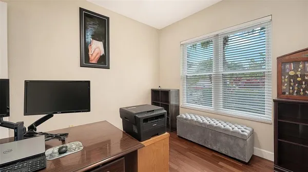 a spacious bedroom with a bed dresser and a window
