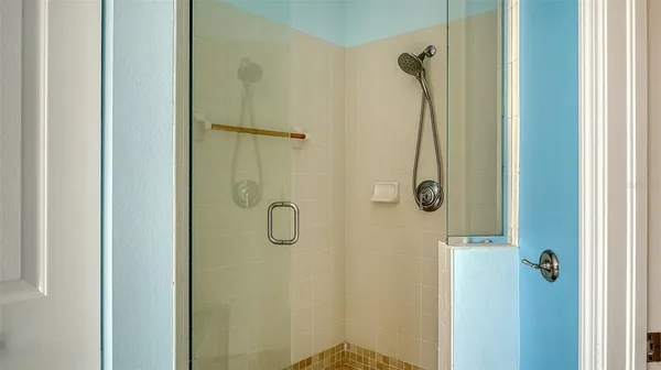 a en suite bathroom with a granite countertop sink and a mirror