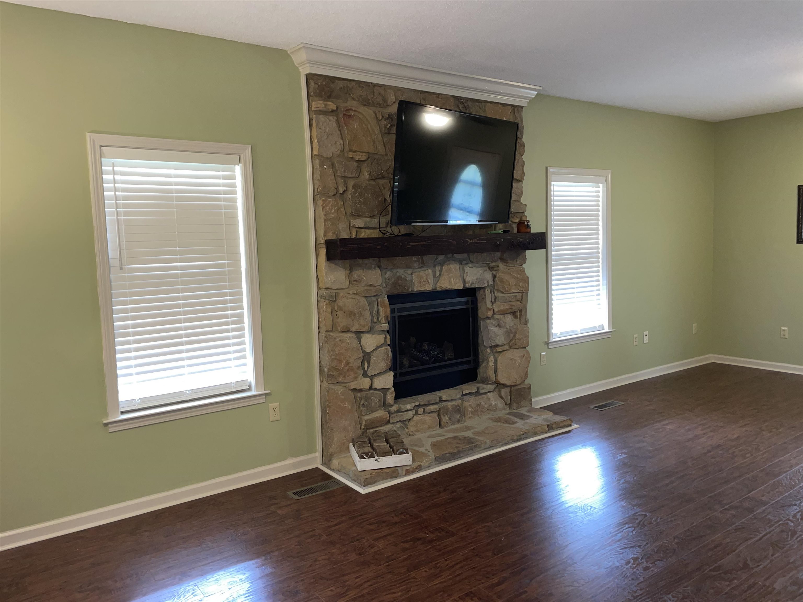 2879 Randolph Road Burlison, TN 38015 - Photo 13 of 29 Unfurnished living room featuring a fireplace and dark wood-type flooring