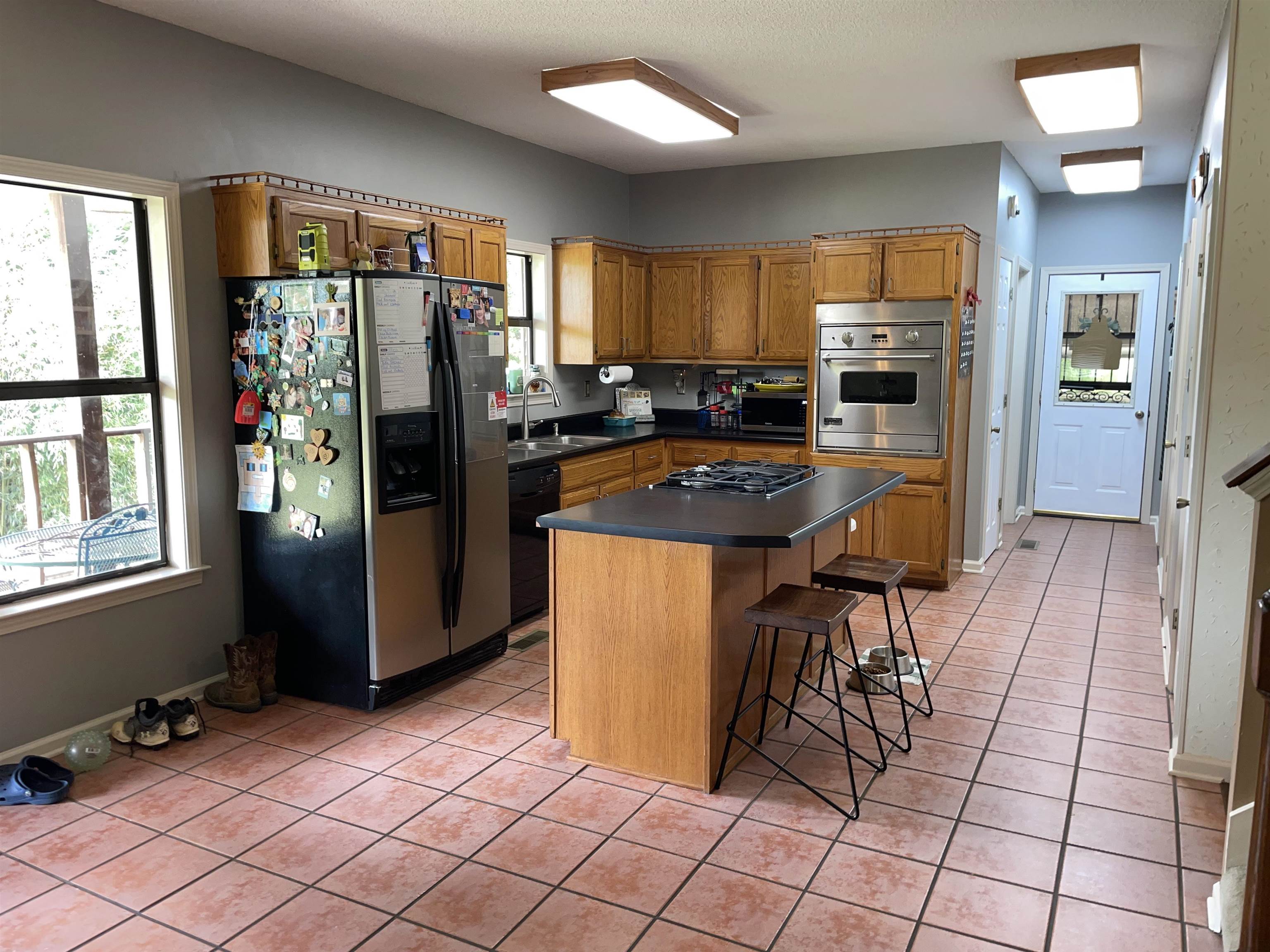2879 Randolph Road Burlison, TN 38015 - Photo 20 of 29 Kitchen featuring plenty of natural light, appliances with stainless steel finishes, light tile patterned floors, a kitchen island, and sink