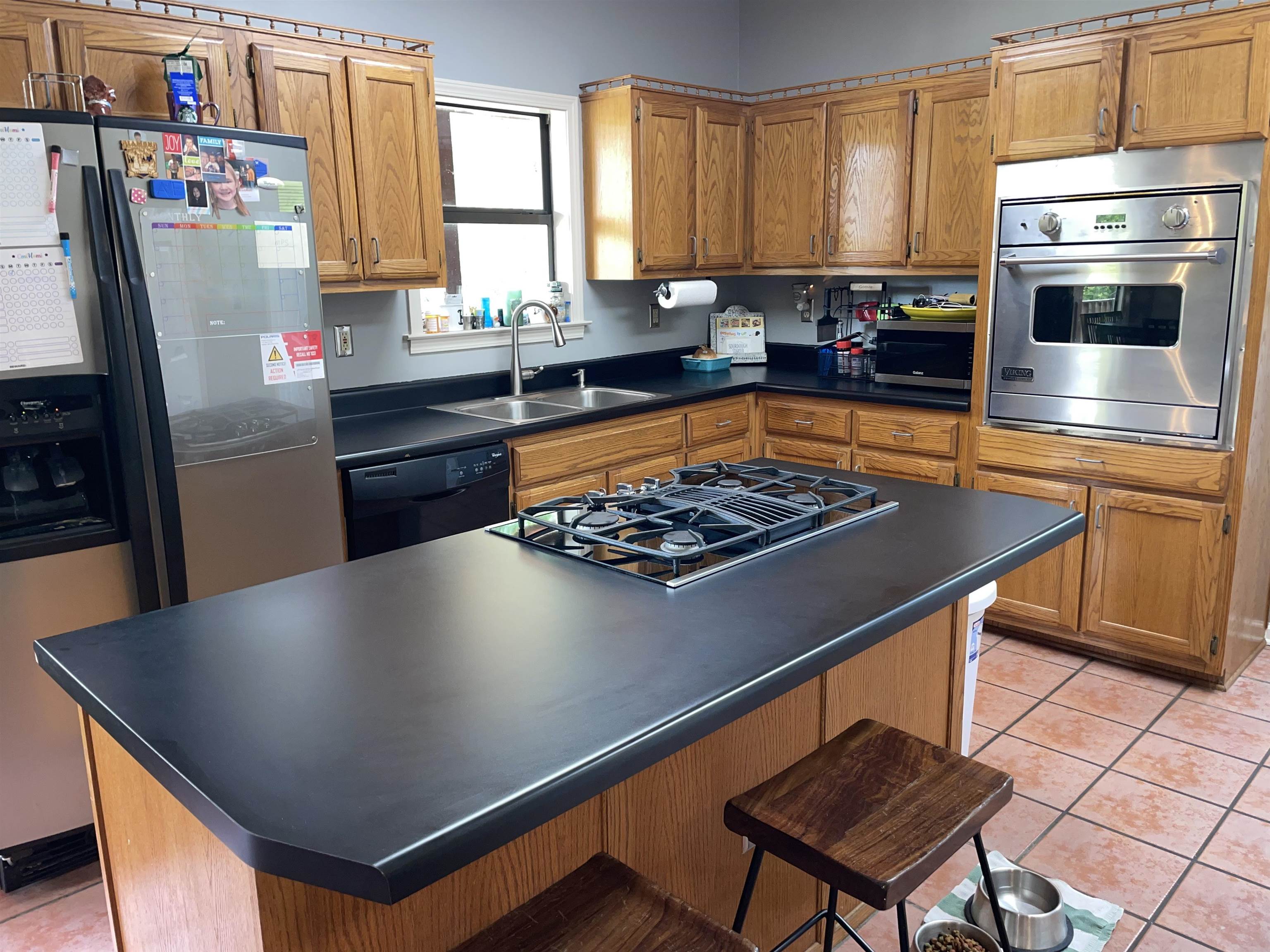 2879 Randolph Road Burlison, TN 38015 - Photo 21 of 29 Kitchen featuring black appliances, sink, light tile patterned flooring, and a kitchen island
