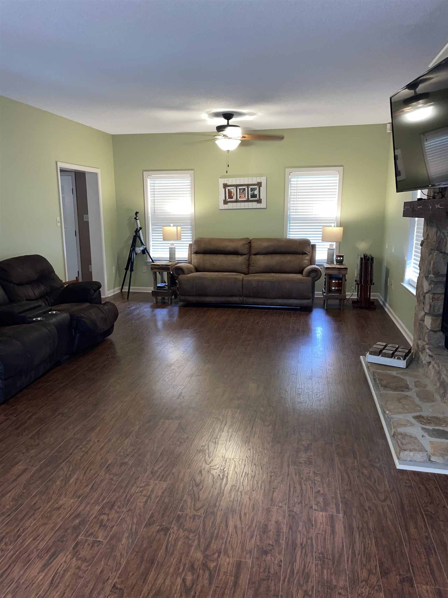 2879 Randolph Road Burlison, TN 38015 - Photo 22 of 29 Living room with a fireplace, dark wood-type flooring, and ceiling fan
