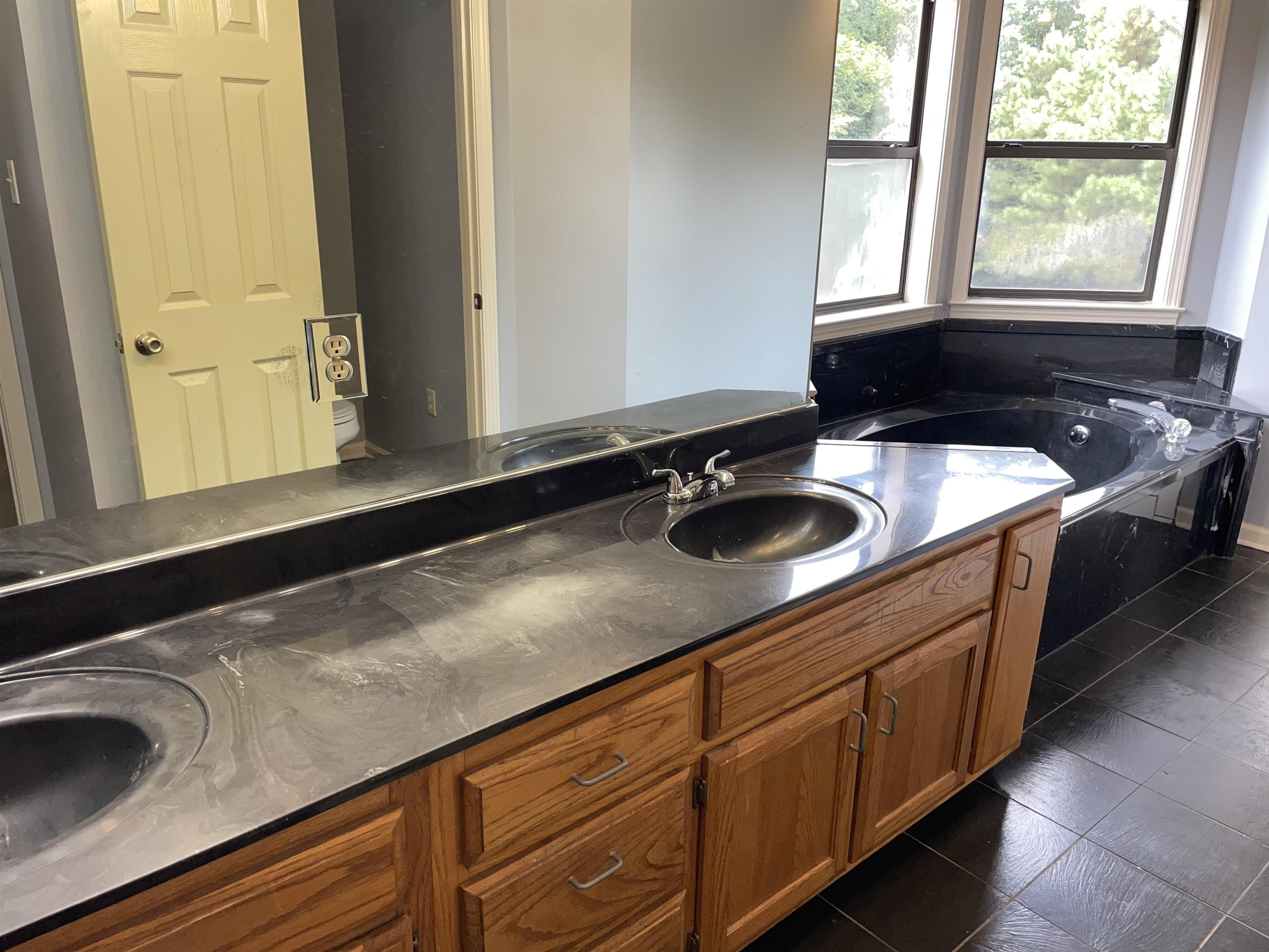 2879 Randolph Road Burlison, TN 38015 - Photo 27 of 29 Bathroom with dual vanity, a bathtub, toilet, and tile patterned flooring