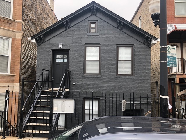 a front view of a house with stairs